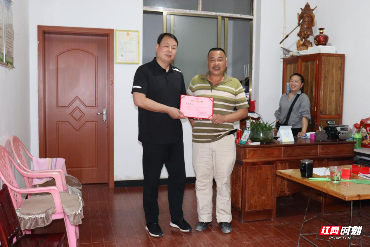 官庄镇党委书记米华勤(左)为社会爱心人士向先高送荣誉证书.