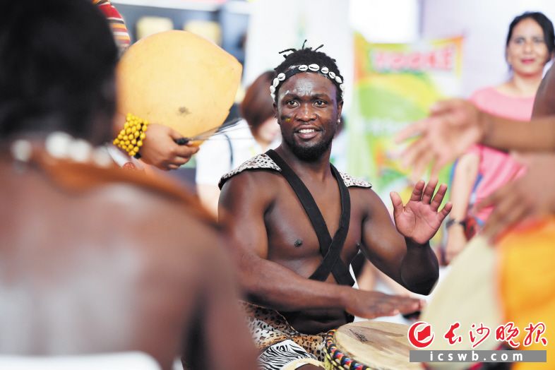 　　乌干达展馆前，一名鼓手在十分投入地击鼓。