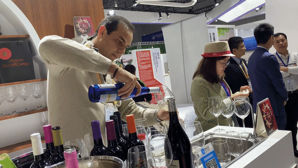 11月7日,在第二届进博会上,摩洛哥红农场酒庄总经理萨耶展示名为“佩内洛普”的白葡萄酒。新华社记者张曼摄