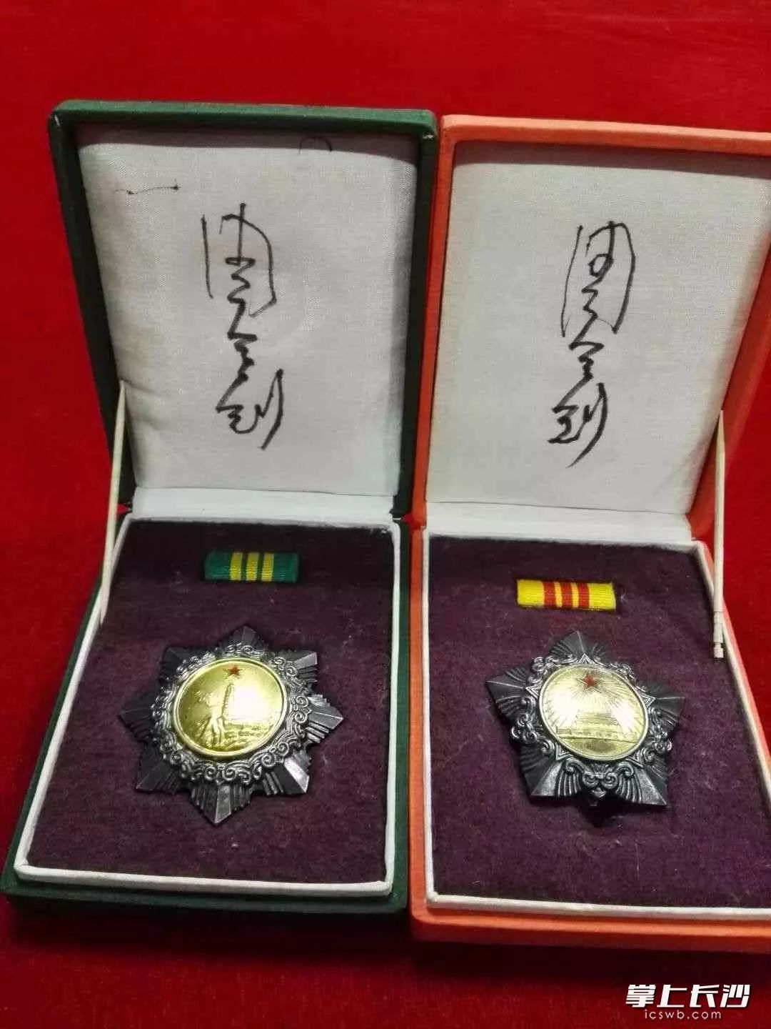 周令钊为罗玉其收藏的三级独立自由勋章、三级解放勋章签名。(勋章为周令钊设计)罗玉其 供图