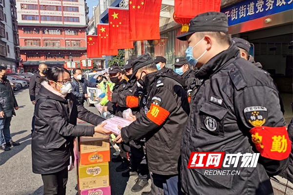 天心区铜铺街小学校长胡雪滢（左）作为代表现场慰问环卫工人及特勤保安人员，并送上口罩等防护用品。.jpg