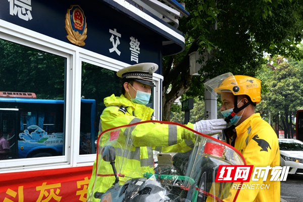 图二：民警示范正确佩戴安全头盔.JPG