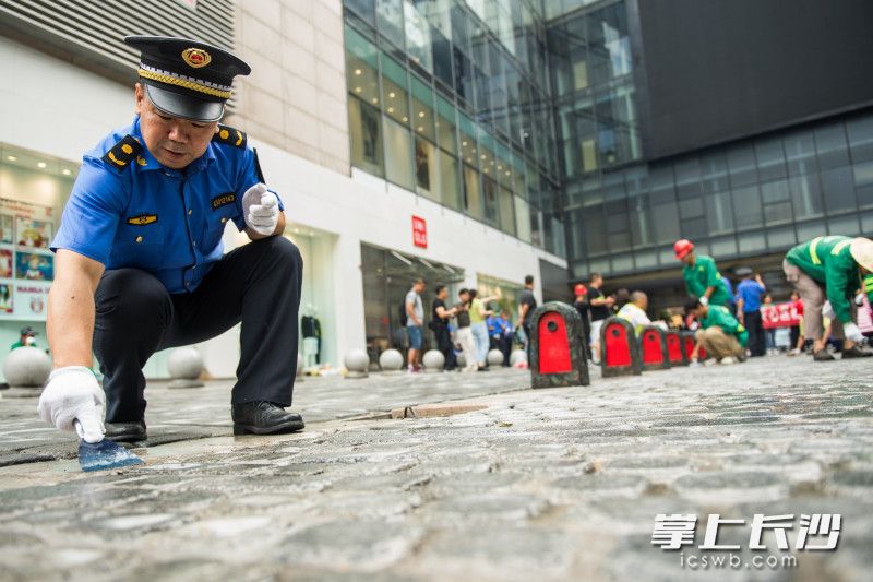 清洁长沙，人人有责。图为日前，长沙城管、社区干部、社区志愿者等齐当“清洁工”，细心扮靓坡子街。长沙晚报全媒体记者  黄启晴 摄
