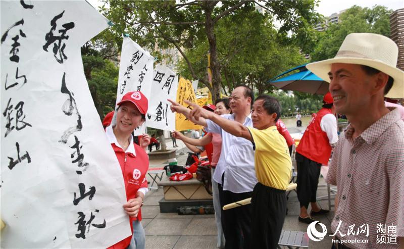 开展书画赠送、文明劝导、医疗服务、垃圾捡拾等志愿服务活动。刘石江 摄