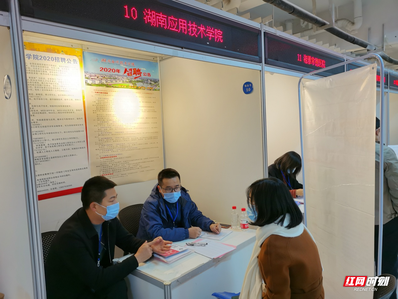 28日上午，武汉大学双选会现场，毕业生在与湖南应用技术学院招聘专员交谈.png
