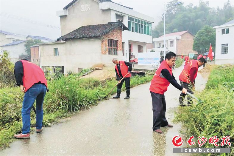 　　宁乡青山桥镇的“百姓路长”正在清扫路面。