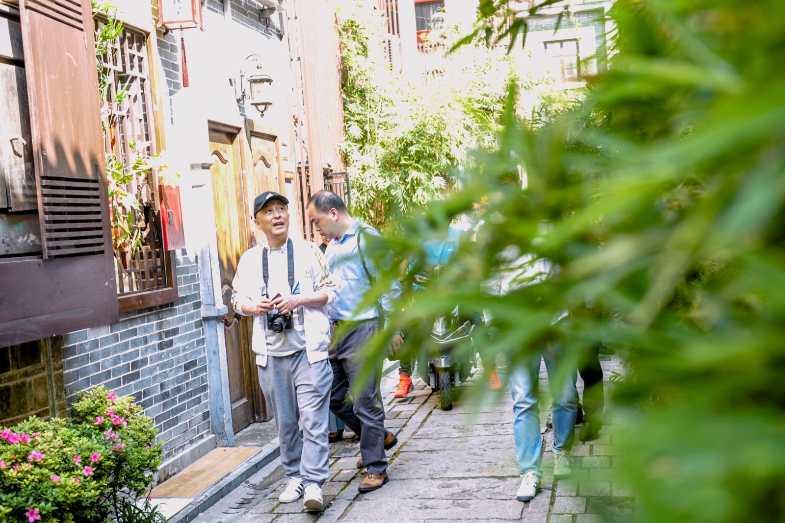 著名作家何立伟（左一）和本报记者一起游走西园北里历史步道“读街”。 全媒体记者 陈飞 摄