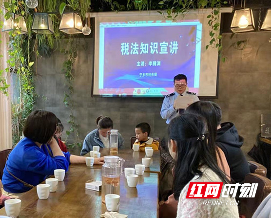 宁乡市税务局第一税务分局干部李腾渊在“亲子课堂”上讲解税法知识。.jpg