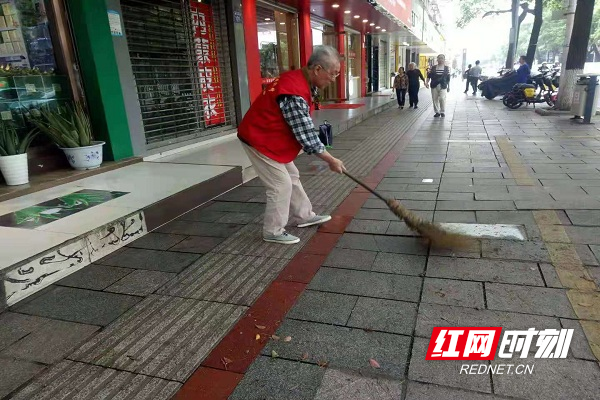 党员志愿者维护人行通道环境卫生.jpg