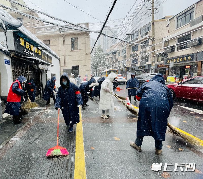 清水塘街道黨員干部志愿者將景區(qū)周邊道路積雪清掃得干干凈凈。 通訊員 陳陽(yáng) 攝