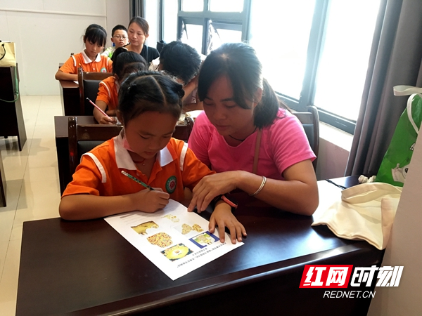 家长与孩子一起在完成老师布置的作业。.jpg
