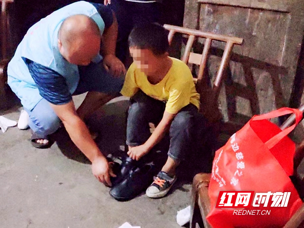 常务副会长龙志飞在帮助困境学生试穿新鞋。.jpg