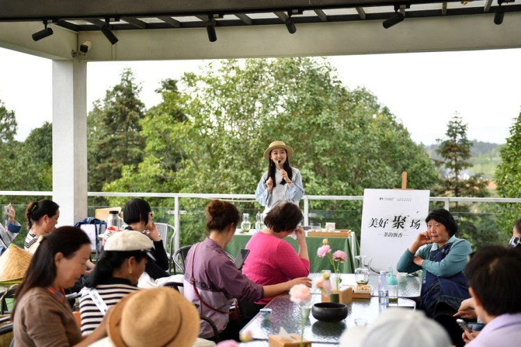 A staff member of a tea tourism industrial park gives tourists a mini-lecture on tea culture in Jinjing Town of Changsha County, central China's Hunan Province, April 7, 2023. (Xinhua/Chen Zhenhai)