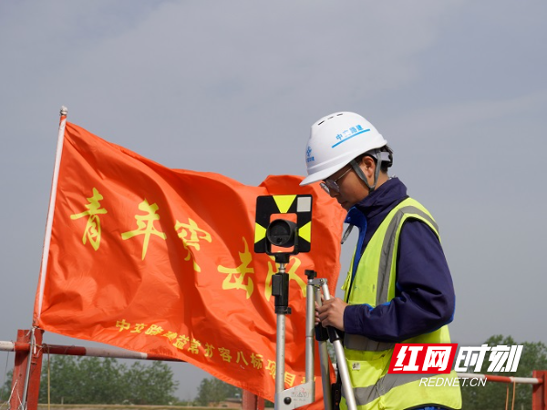 测量员正在烈日下校对测量仪器，为施工提供精准数据。.jpg