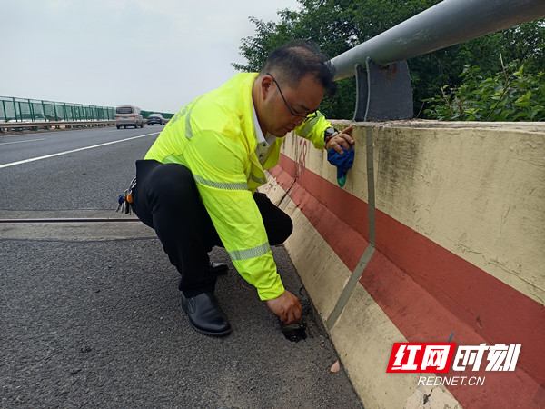 图2 养护队员在雨前巡检时，检查桥梁排水系统通畅情况.jpg