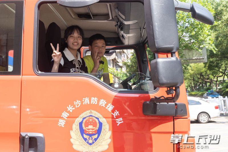 在“蓝朋友”的指导下，姐弟俩坐上消防车，切切实实过了一把当消防员的瘾。