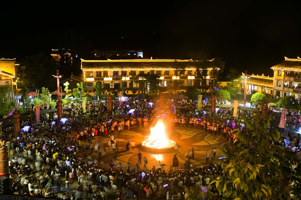 Residents gather at a square in Qingshan Village, Guizhou to celebrate the Torch Festival on July 25, 2019. /CFP