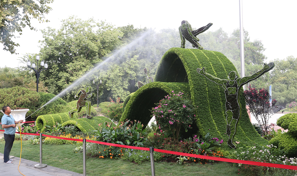 An Asian Games-themed flower landscape is seen on a street in Hangzhou, Zhejiang Province on September 12, 2023. /CFP