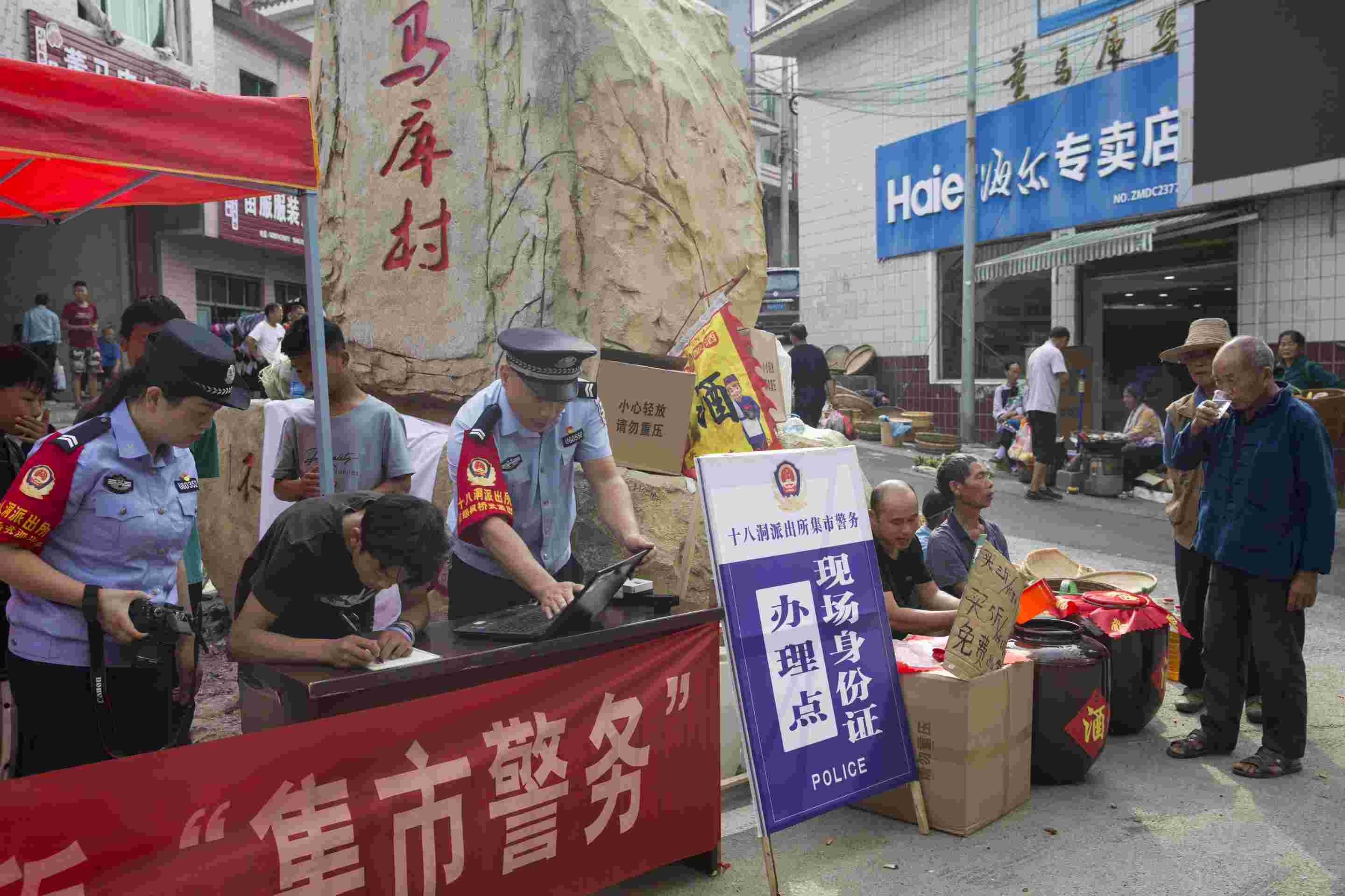 在董马库村十八洞派出所“集市警务点”,民辅警们正在为群众办理身份证业务。(单位供图) 在董马库村十八洞派出所“集市警务点”,民辅警们正在为群众办理身份证业务。(单位供图)