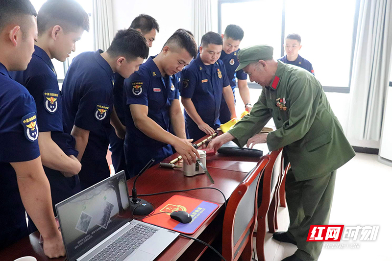 刘欲求在石峰消防大队参加“传承红色基因 老兵宣讲”活动，并向消防官兵展示参战使用的多用途水壶。.jpg