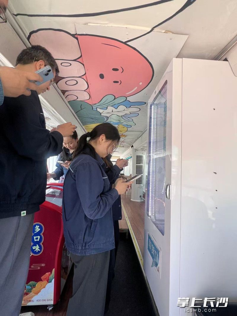 “长电在行动”爱心自动售卖机上，公司员工纷纷前来消费，而他们这些消费的净利润也将自动归入“长电在行动”爱心助学基金，托起偏远地区孩子的“求学梦”。