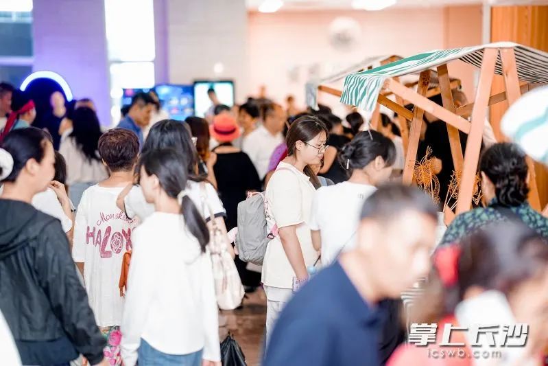 线下现场，非遗体验区人潮如织。