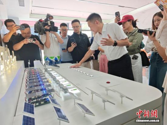 长沙一新能源技术有限公司负责人向媒体记者介绍相关创新产品。中新网记者 唐小晴 摄